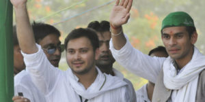 PATNA, INDIA - MAY 15: RJD Chief Lalu Prasad Yadav and Rabri Devi?s sons Tej Pratap and Tejashwi Yadav (L) at Parivartan Rally at Gandhi Maidan on May 15, 2013 in Patna, India. Addressing his first major rally in Bihar in a decade, 65 year old RJD supremo called Chief Minister Nitish Kumar a dictator. (Photo by AP Dubey/Hindustan Times via Getty Images)